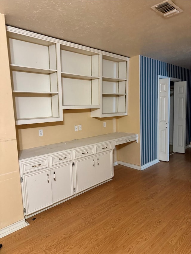 kitchen featuring white cabinetry and light wood-type flooring