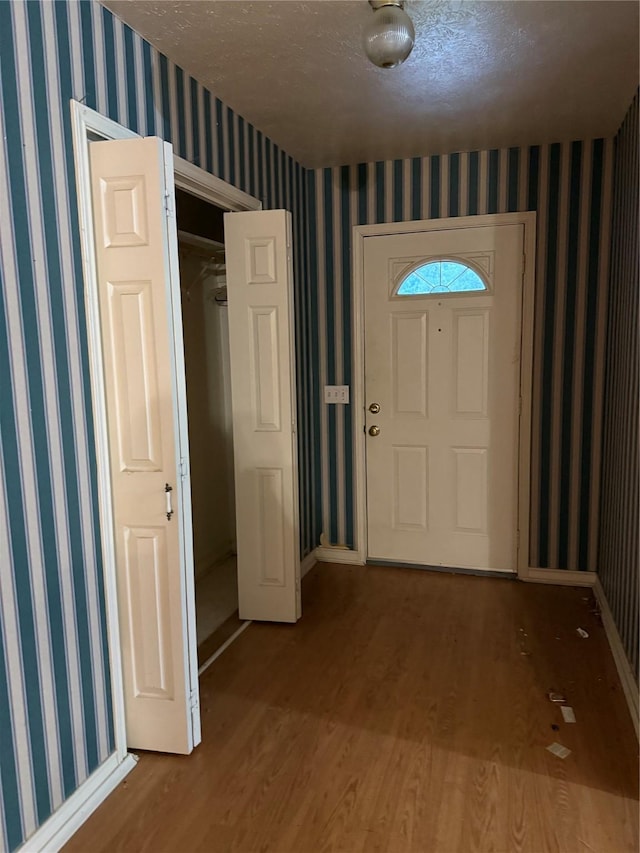 entrance foyer with wood-type flooring and a textured ceiling