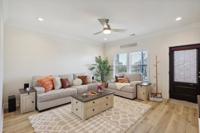 living room with ceiling fan, ornamental molding, and light hardwood / wood-style flooring