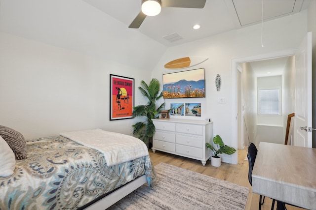 bedroom featuring ceiling fan, vaulted ceiling, and light hardwood / wood-style flooring