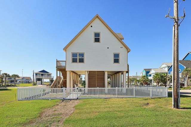 rear view of property with a lawn and a carport