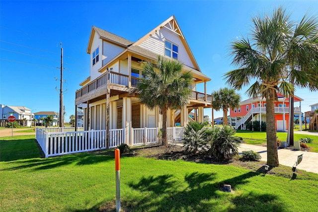 view of front of house featuring covered porch and a front yard