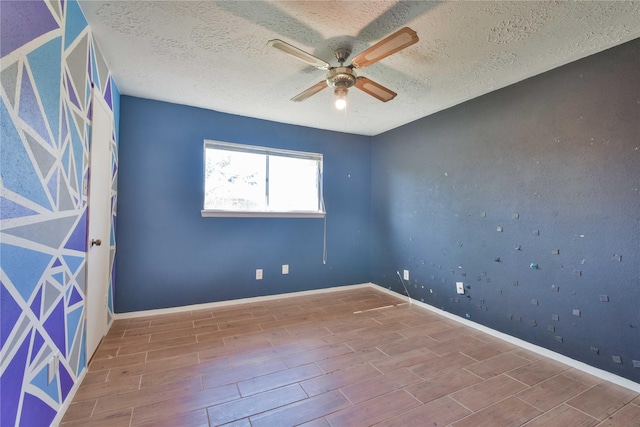 spare room featuring ceiling fan and a textured ceiling