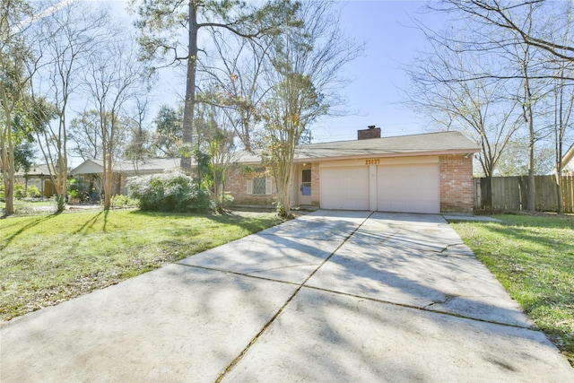 ranch-style home featuring a garage and a front lawn