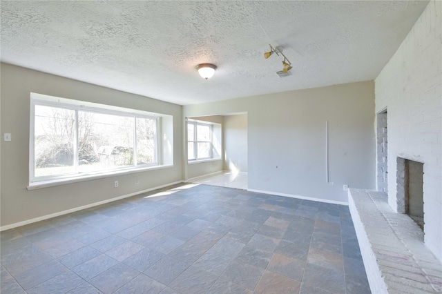 unfurnished living room with a fireplace and a textured ceiling