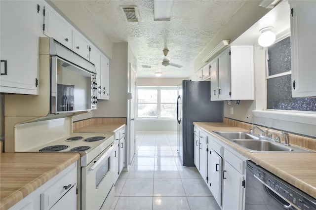 kitchen with ceiling fan, sink, dishwasher, white electric range, and white cabinetry