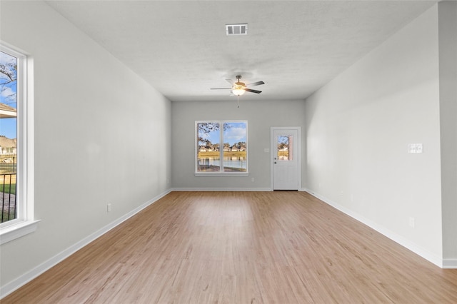 unfurnished room with ceiling fan and light hardwood / wood-style flooring