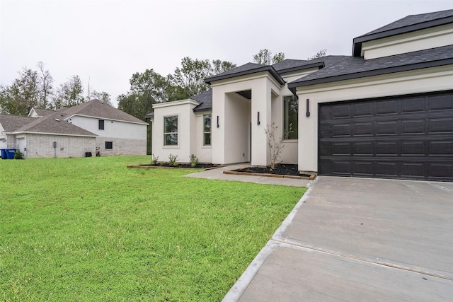 view of front of property featuring a garage and a front lawn