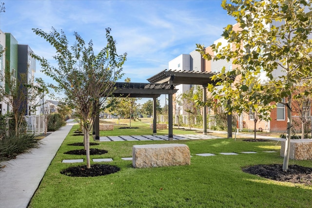 view of community featuring a yard and a pergola