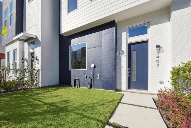 doorway to property featuring a yard