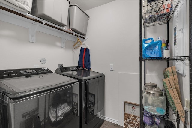 laundry room featuring washer and dryer and wood-type flooring