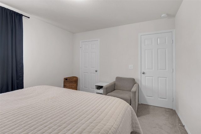 bedroom featuring light colored carpet