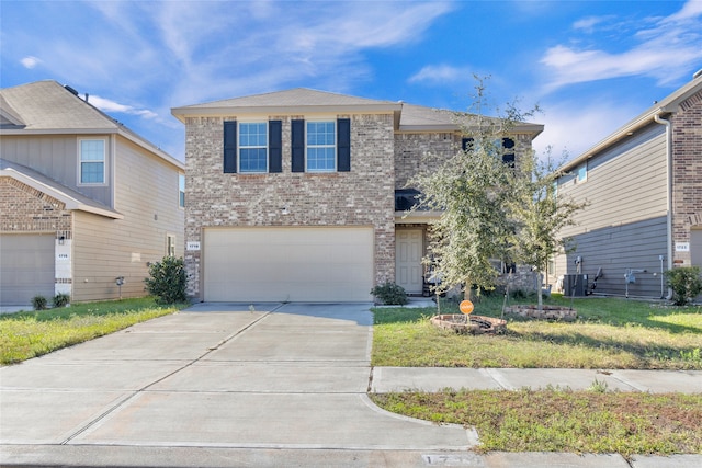 view of property with a garage, a front yard, and central AC