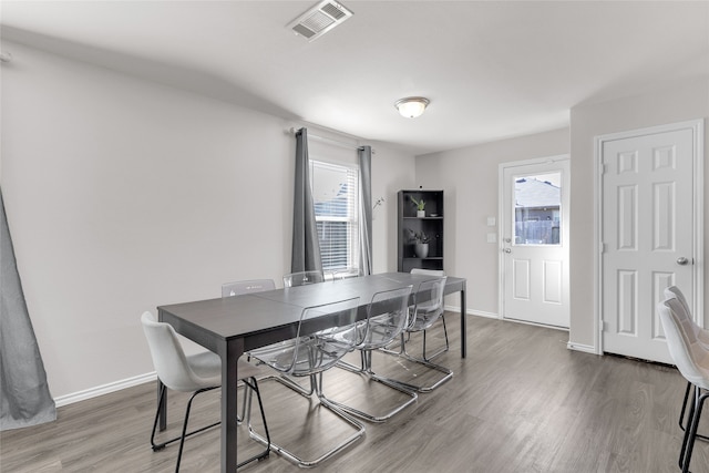 dining room with hardwood / wood-style flooring and plenty of natural light