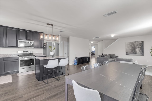 dining area with dark hardwood / wood-style flooring