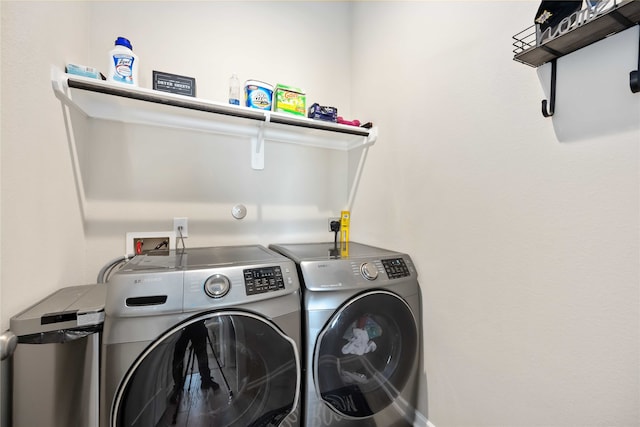 clothes washing area featuring independent washer and dryer