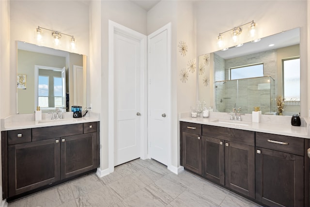 bathroom featuring a tile shower and vanity