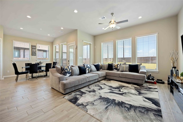 living room with ceiling fan and light wood-type flooring