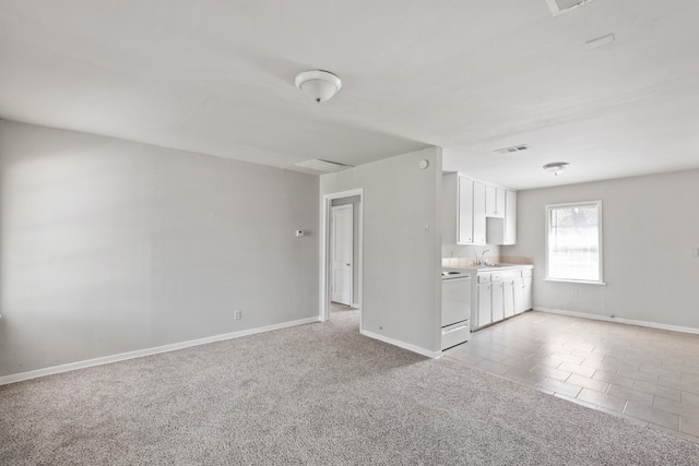 carpeted spare room featuring sink