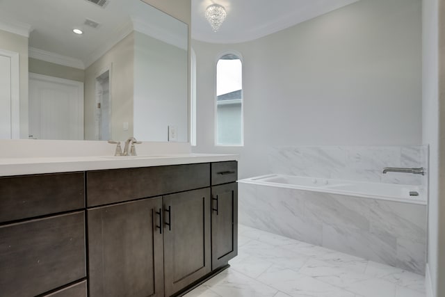 bathroom featuring vanity, ornamental molding, and tiled tub