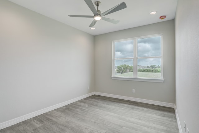 spare room with ceiling fan and light hardwood / wood-style flooring