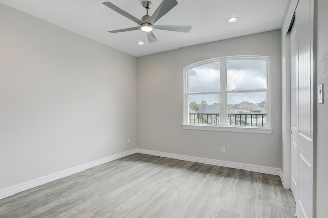 unfurnished room with ceiling fan and light wood-type flooring