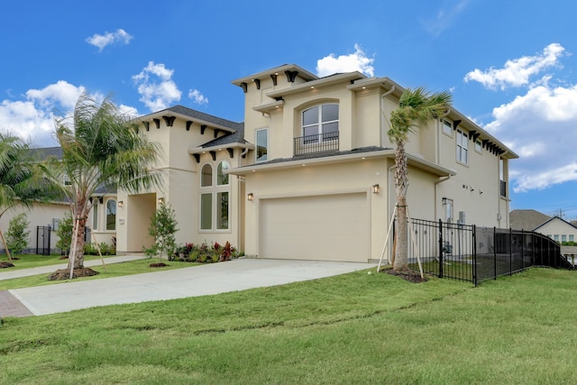 mediterranean / spanish-style house featuring a front yard and a garage