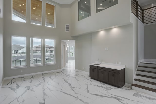 living room featuring a healthy amount of sunlight and a high ceiling