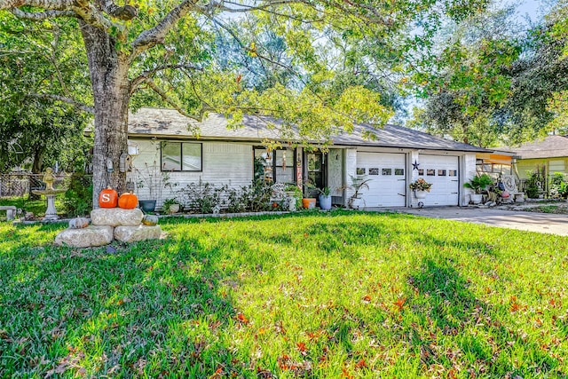 ranch-style home with a front yard and a garage