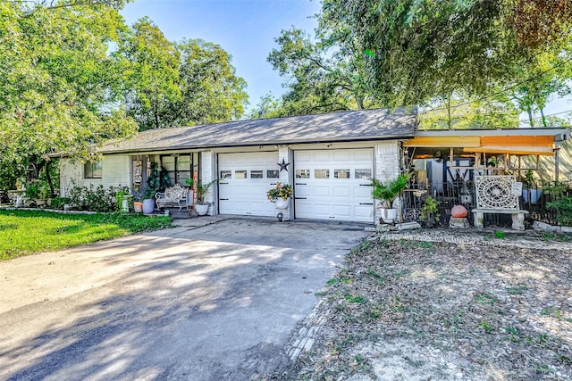 1215 Esther St, Kemah, TX 77565 - view of front facade with a garage, concrete driveway, and a porch