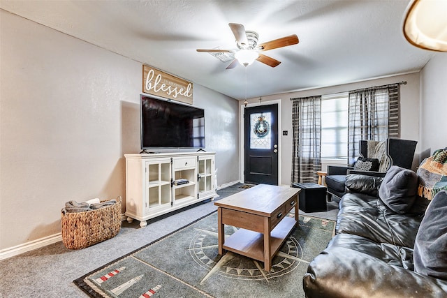 carpeted living room featuring a textured ceiling and ceiling fan