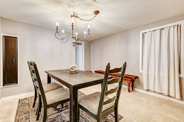 dining room with light tile patterned flooring, a textured ceiling, and an inviting chandelier