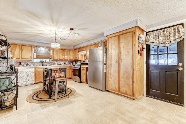 kitchen with pendant lighting, decorative backsplash, a textured ceiling, light tile patterned flooring, and stainless steel appliances