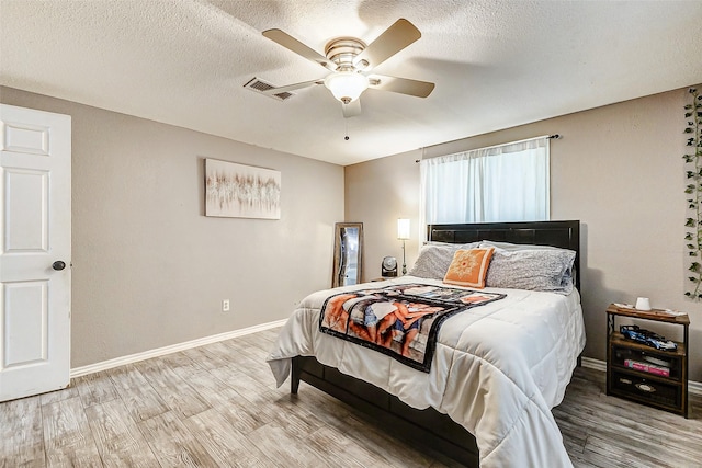 1215 Esther St, Kemah, TX 77565 - bedroom with wood finished floors, baseboards, ceiling fan, and a textured ceiling