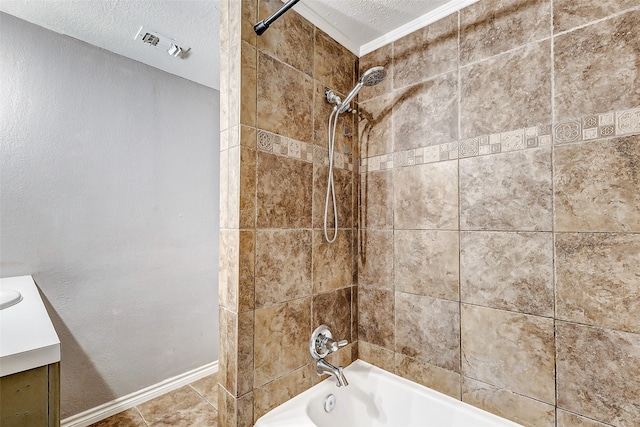 bathroom featuring tiled shower / bath combo, tile patterned floors, crown molding, a textured ceiling, and vanity