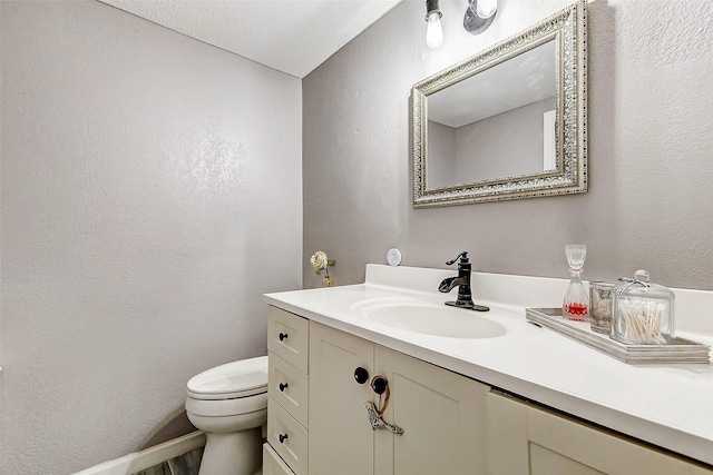 1215 Esther St, Kemah, TX 77565 - half bathroom featuring toilet, vanity, and a textured wall