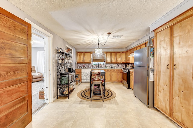 1215 Esther St, Kemah, TX 77565 - kitchen with appliances with stainless steel finishes, light countertops, a sink, pendant lighting, and light tile patterned floors
