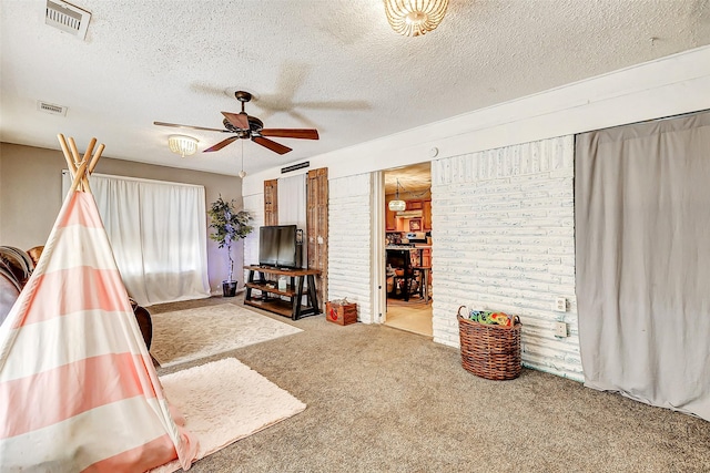 1215 Esther St, Kemah, TX 77565 - living room featuring carpet floors, a ceiling fan, and a textured ceiling