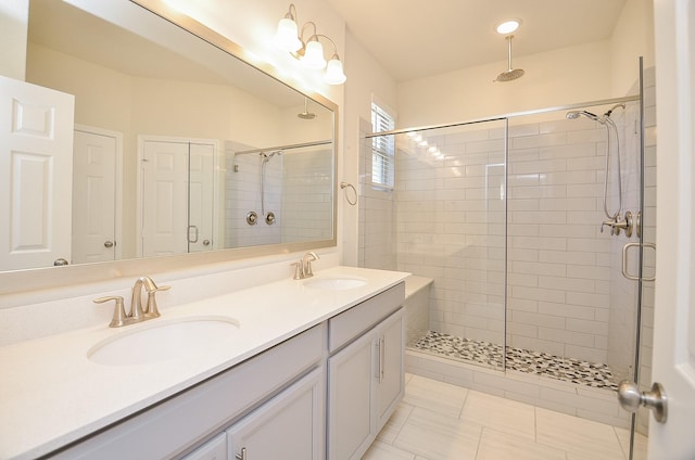 bathroom featuring tile patterned floors, vanity, and a shower with shower door