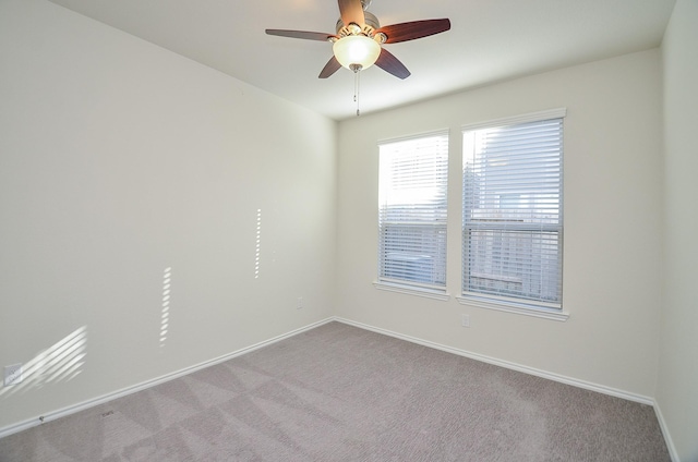 spare room with light carpet and ceiling fan