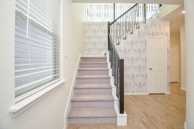 stairway with hardwood / wood-style flooring