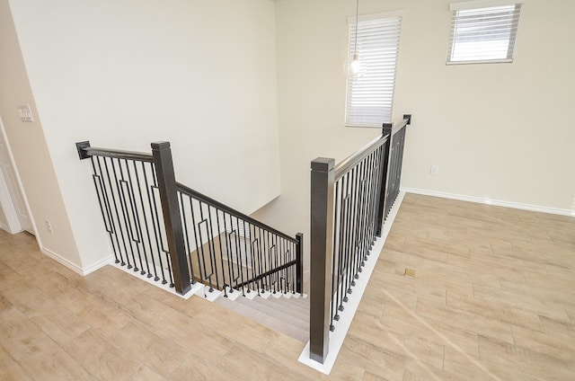 stairs with hardwood / wood-style floors