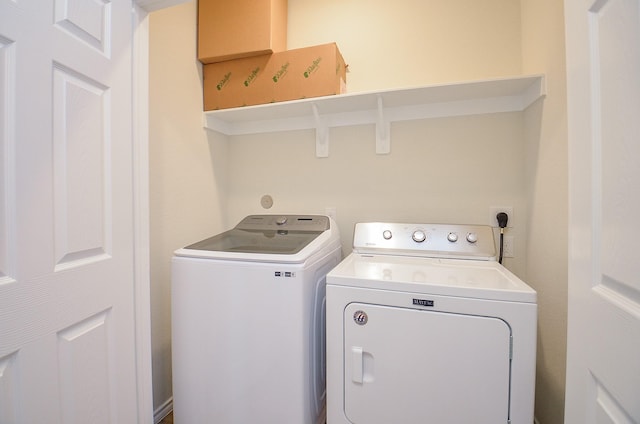 clothes washing area featuring washer and dryer