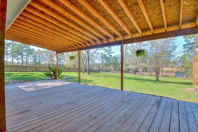 wooden terrace featuring a lawn