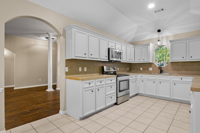 kitchen with sink, white cabinets, stainless steel appliances, and light hardwood / wood-style flooring