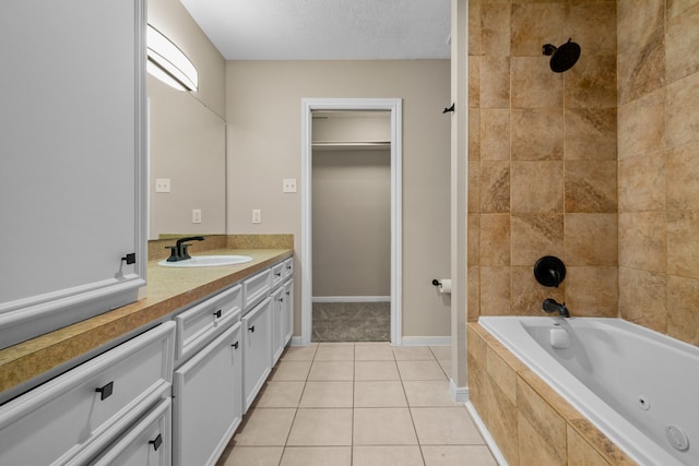 bathroom with tile patterned floors, vanity, and a textured ceiling