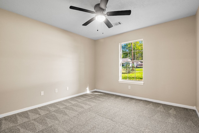 spare room featuring carpet, a textured ceiling, and ceiling fan