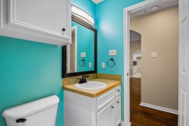 bathroom featuring hardwood / wood-style flooring, vanity, and toilet