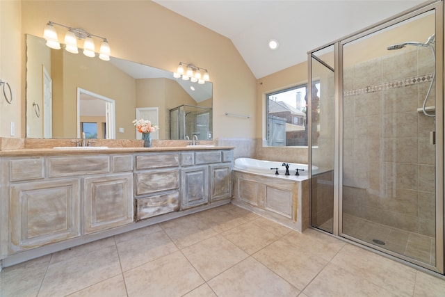 bathroom with tile patterned floors, plus walk in shower, vanity, and vaulted ceiling