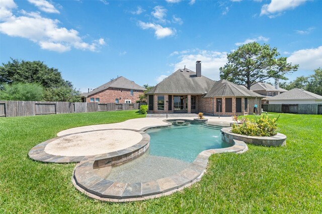 view of pool with a lawn and a patio area